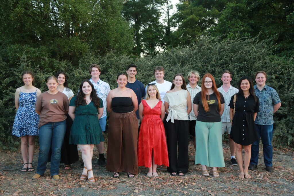 a group of people standing in a group posing for a photograph to mark their achievements